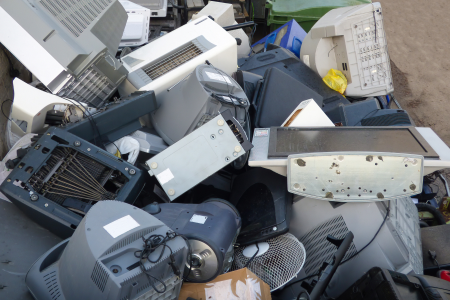 a bunch of IT equipment and electronic waste in a pile